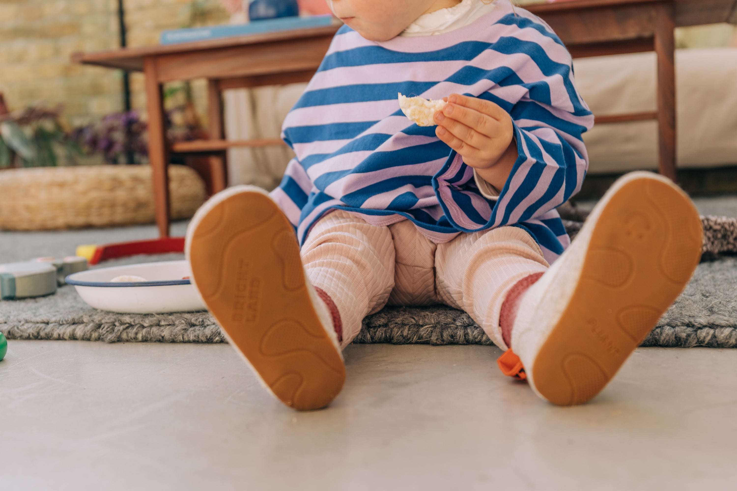 Toddler eating in PreWalker Rose shoes